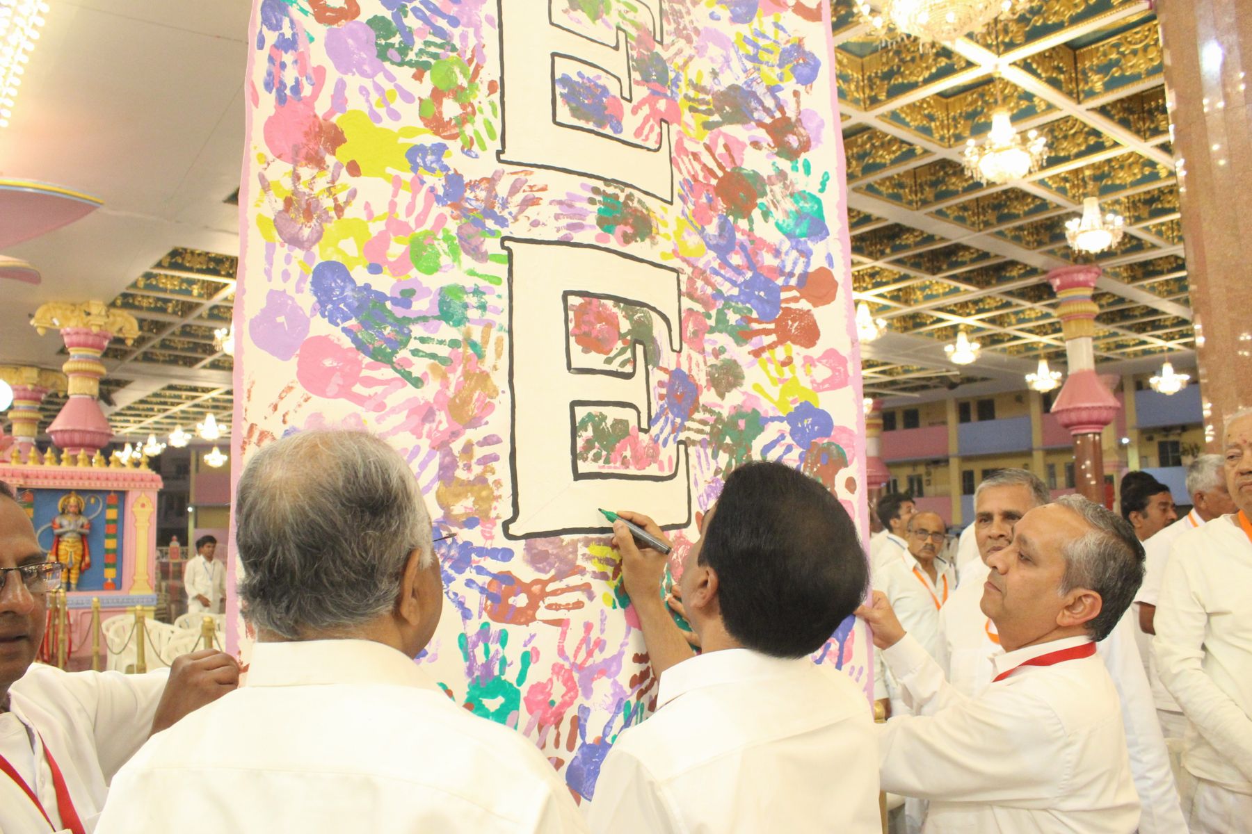 Managing Trustee signing the commemorative handprint banner