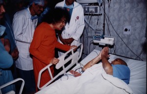 Swami speaking to a patient in ICU