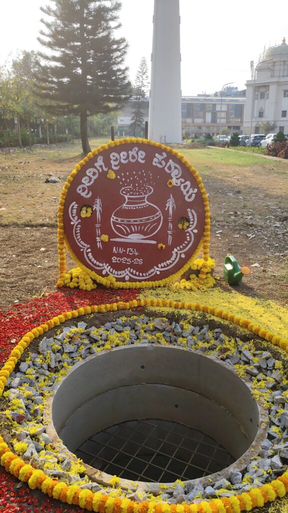 A finished percolation well: concrete ring with steel safety mesh, pebble packing around it