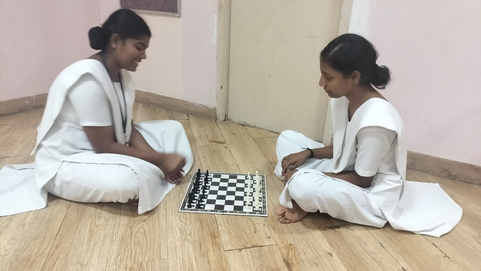 Two nursing students playing chess