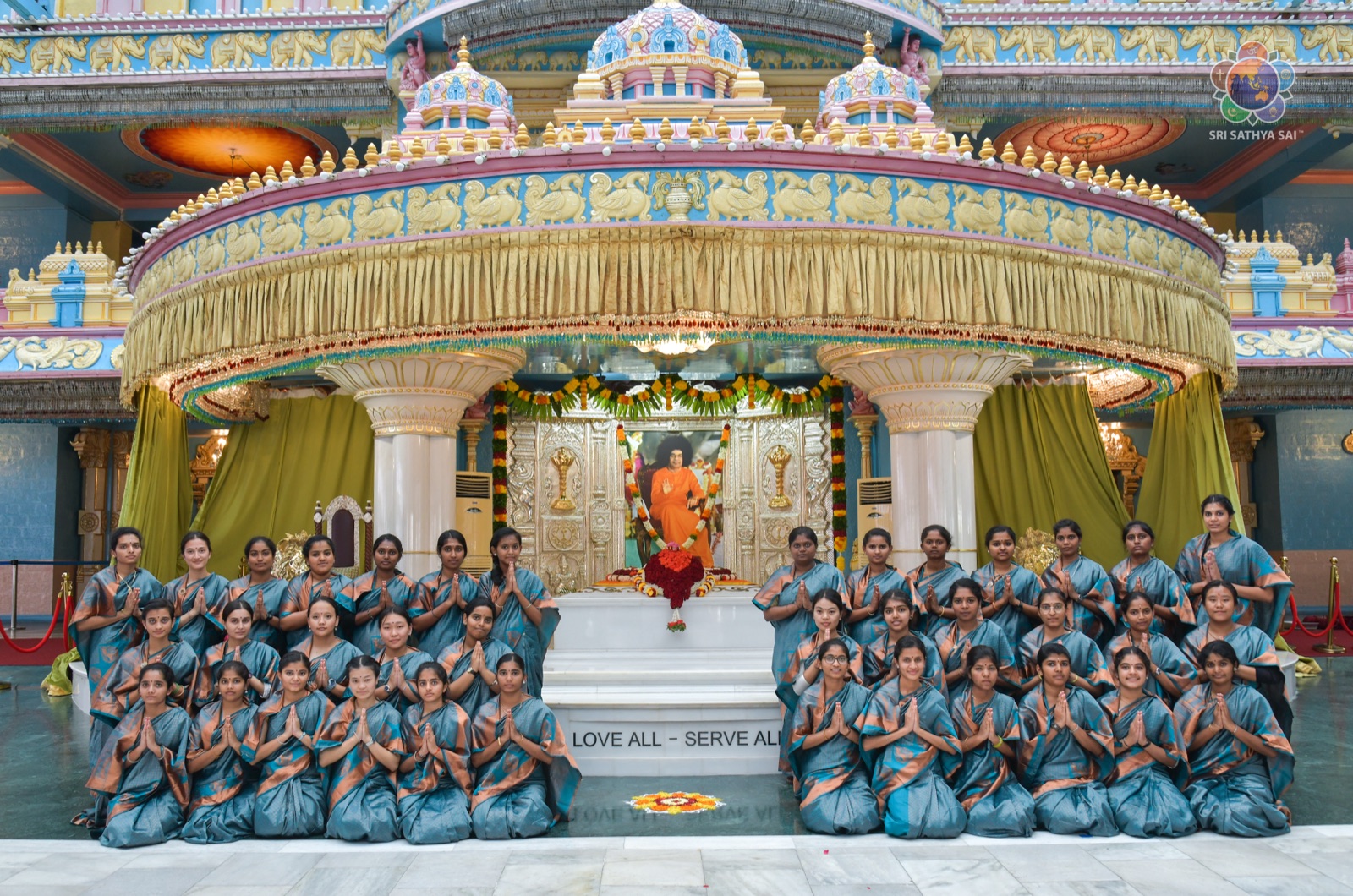 Nursing students in saris with folded hands at the Crystal Anniversary celebrations