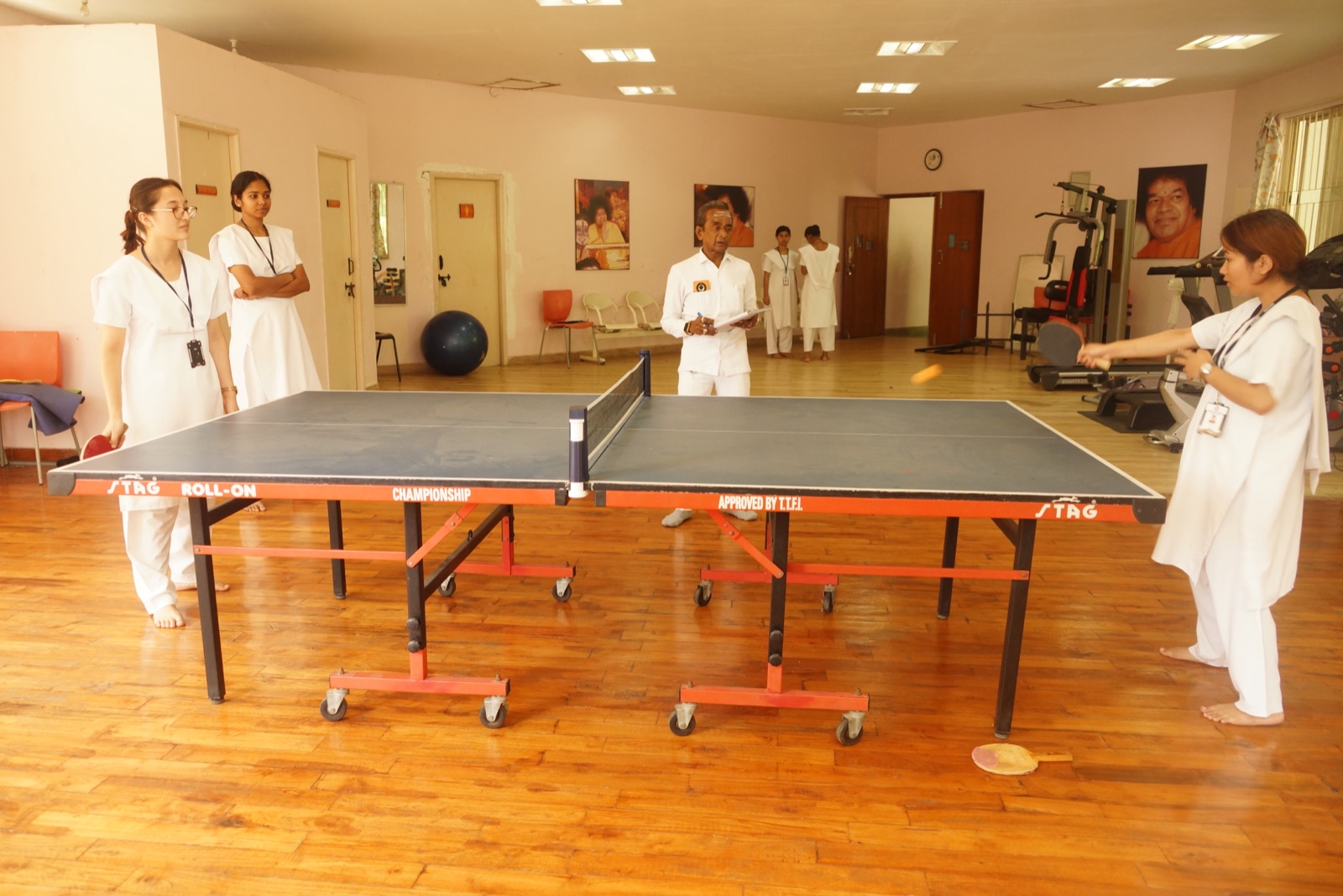 Nursing students playing table tennis indoors