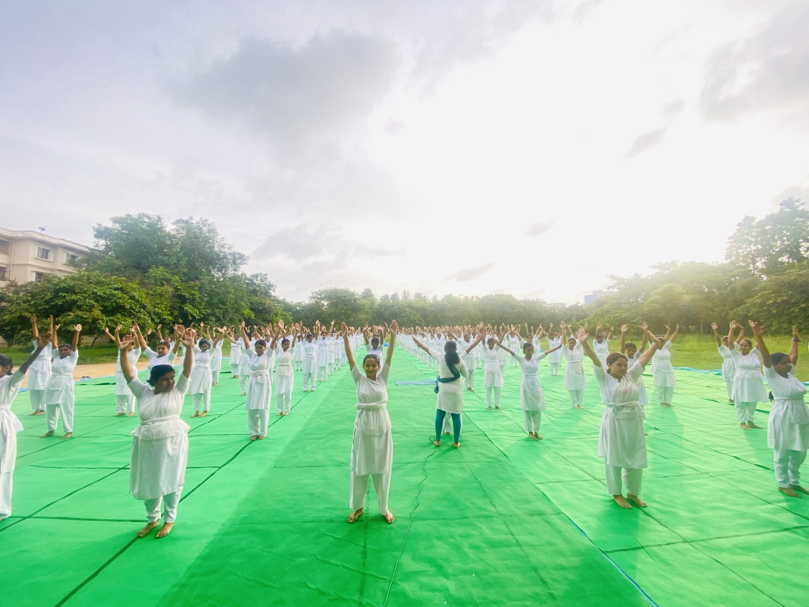 Nursing students practising yoga together outdoors