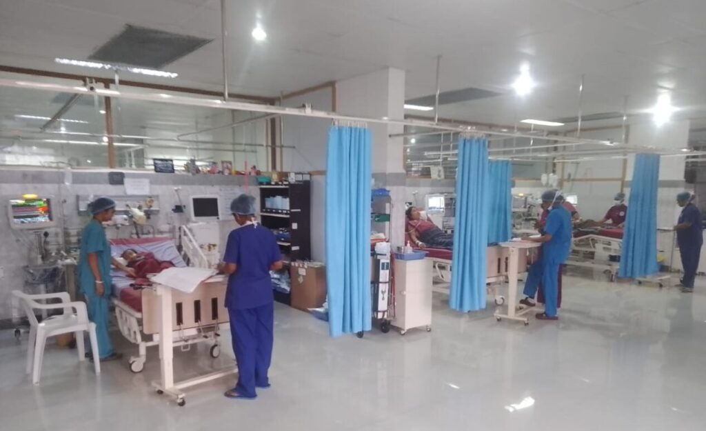 A view across the cardiac surgery ICU, with nurses at the bedsides
