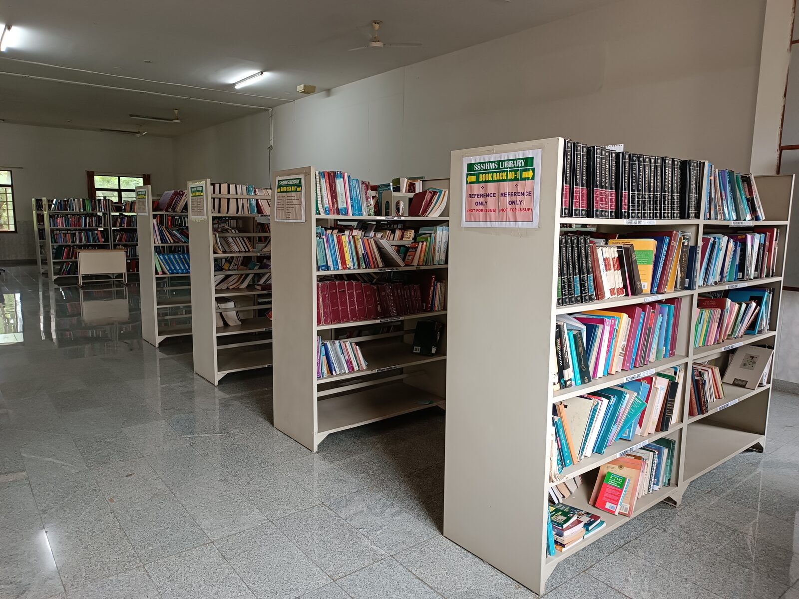 Book racks in the hospital library, with the reference-only rack in front